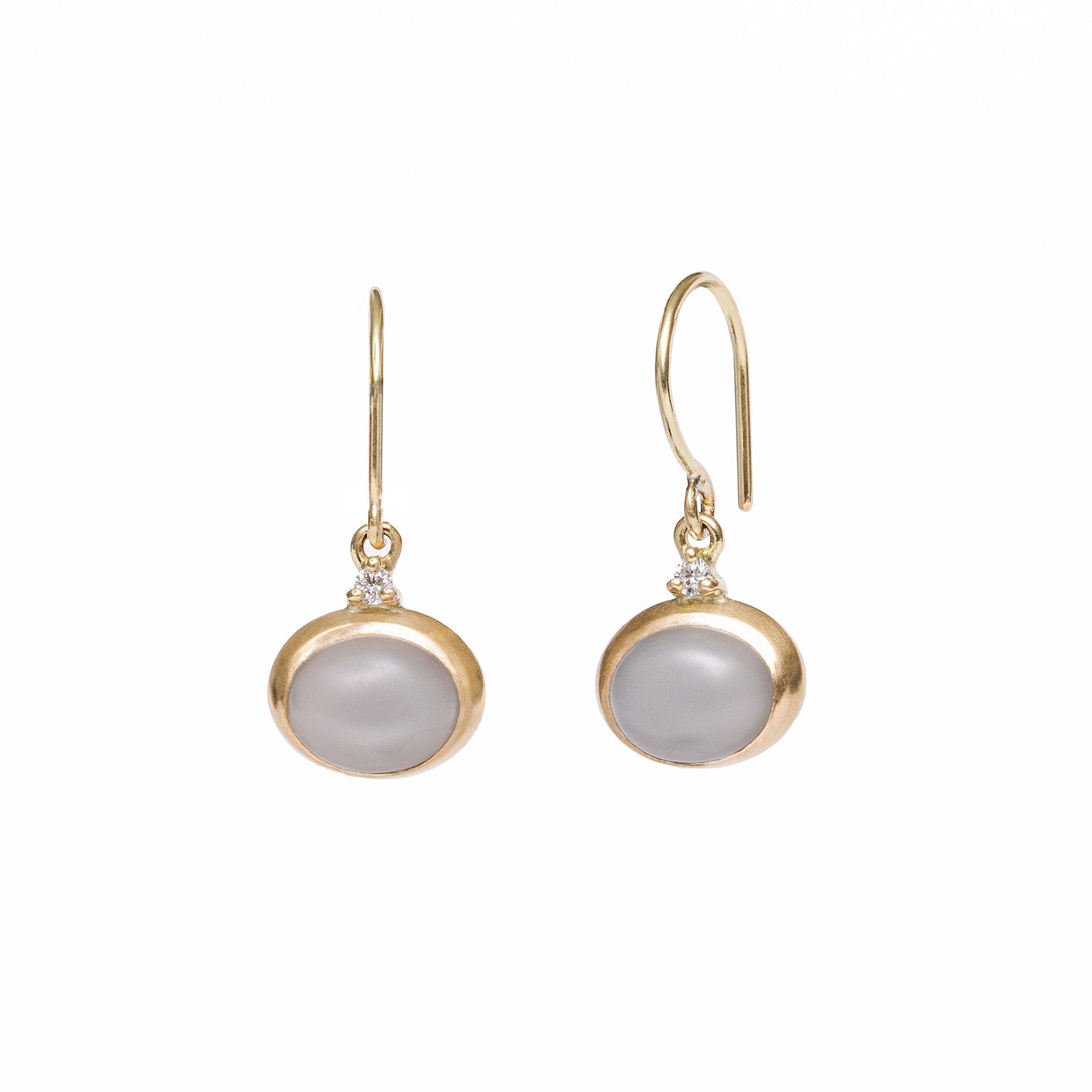 Gold earrings with gray gemstones on a white background