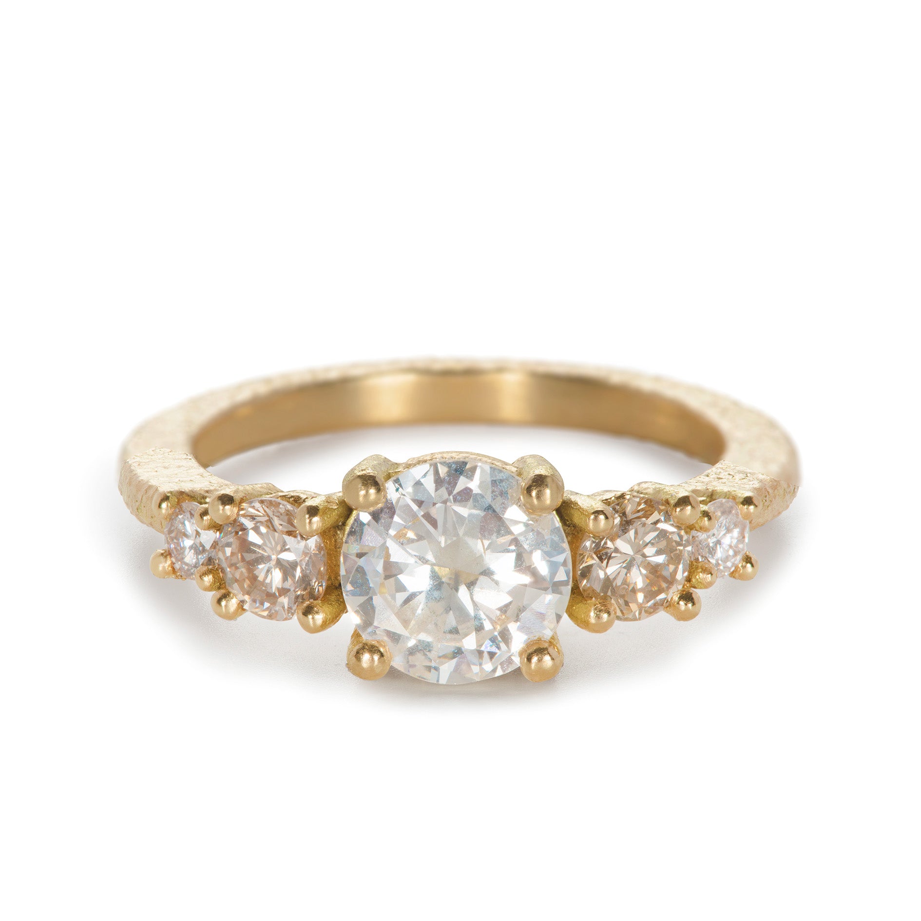 Gold ring with five diamonds on a white background