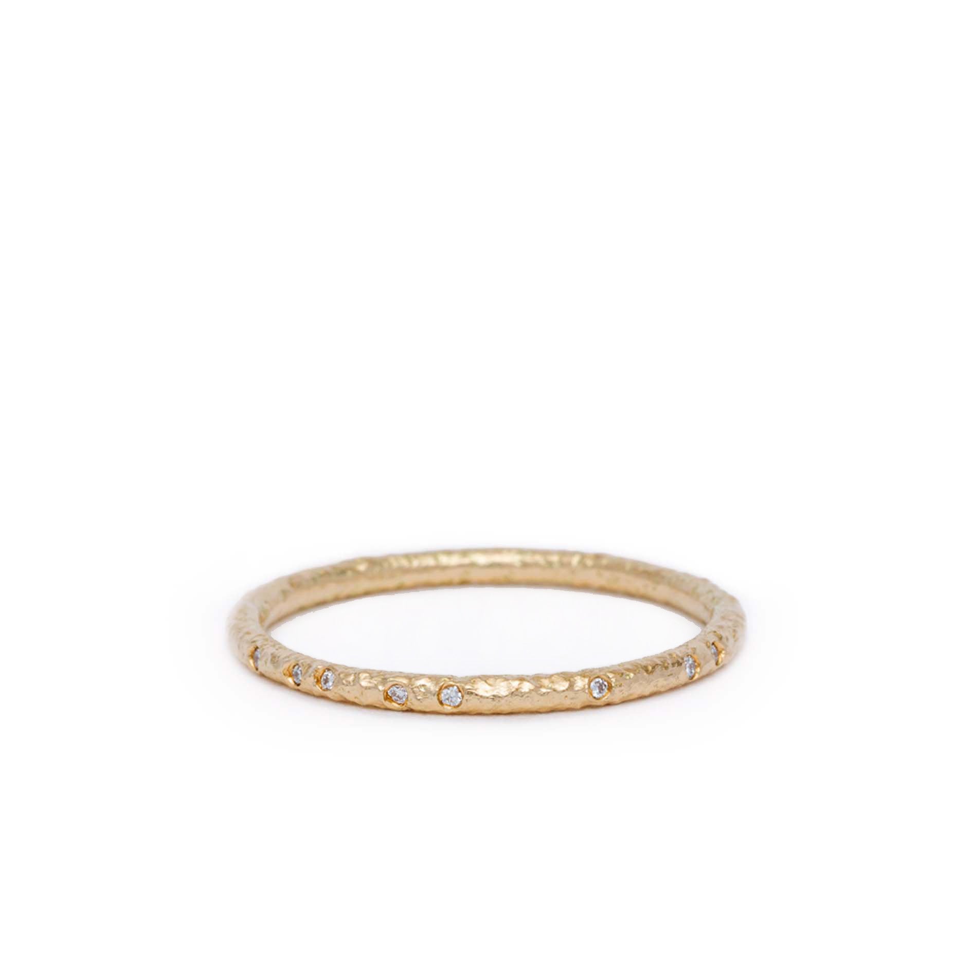 Gold ring with small diamonds on a white background