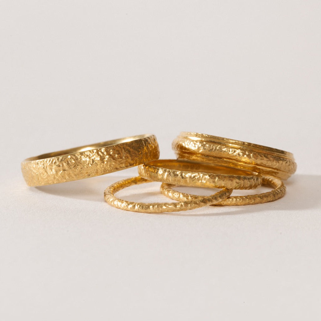 maya selway fine jewellery still life, scattering of textured 18ct yellow gold rings