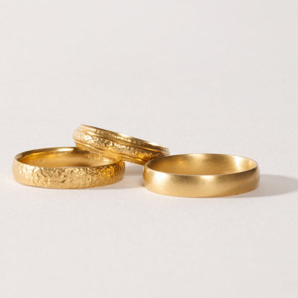 maya selway fine jewellery still life, scattering of textured and matte  18ct yellow gold rings