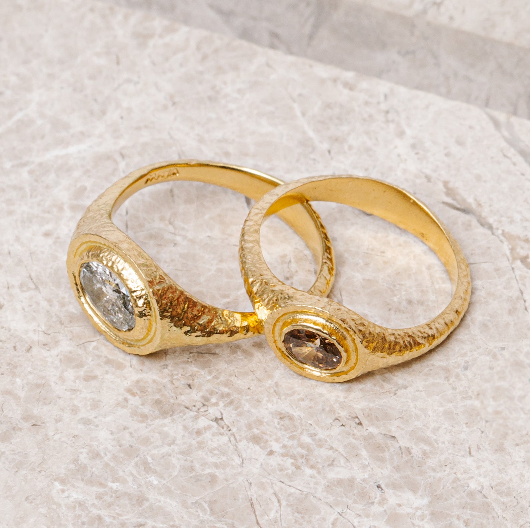 maya selway fine jewellery still life, scattering of textured 18ct yellow gold and diamond rings