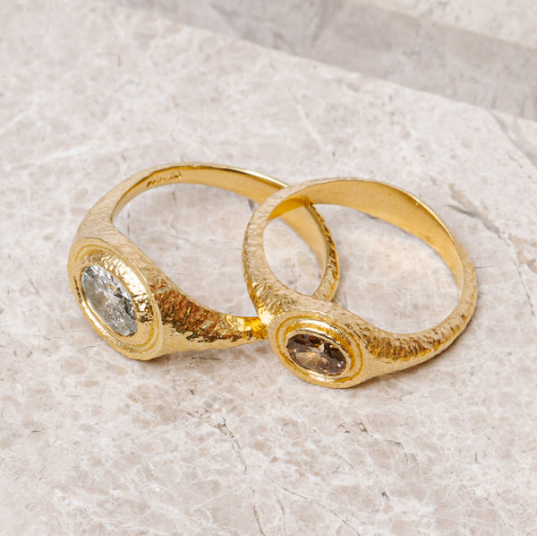 maya selway fine jewellery still life, scattering of textured 18ct yellow gold and diamond rings