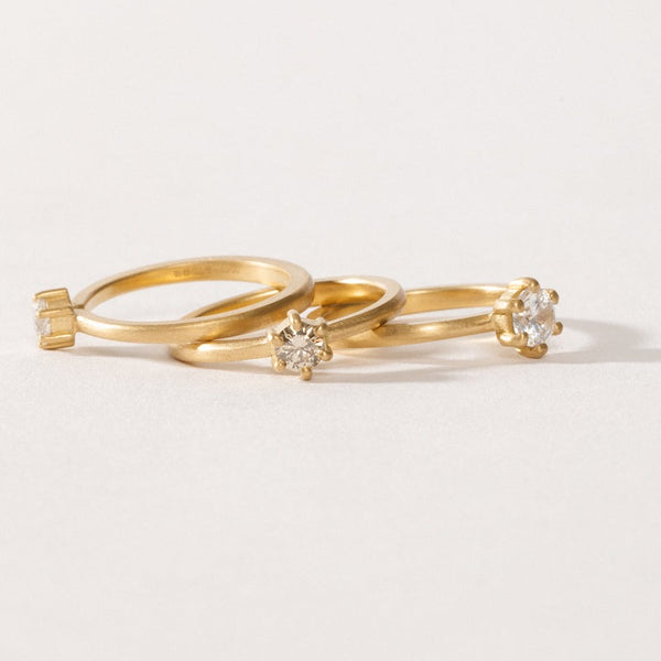 maya selway fine jewellery still life, scattering of three matte 18ct yellow gold and diamond rings