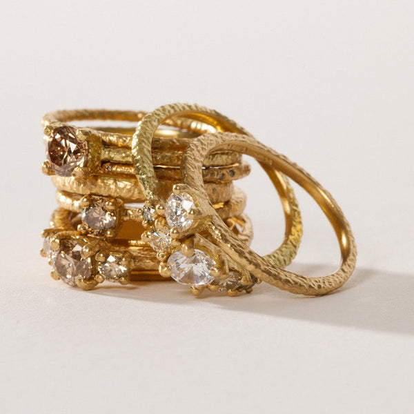 maya selway fine jewellery still life, stack of many textured 18ct yellow gold and diamond rings