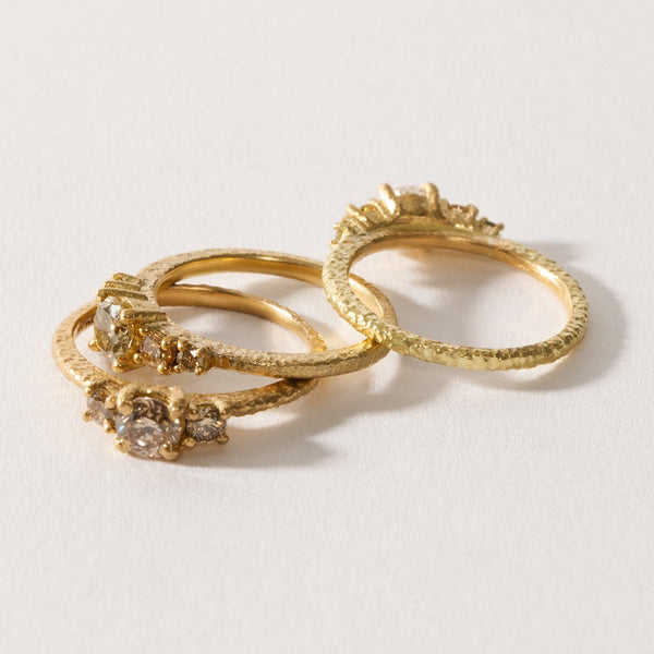 maya selway fine jewellery still life, scattering of three textured 18ct yellow gold and diamond rings