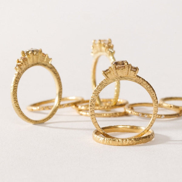 maya selway fine jewellery still life, scattering of 18ct yellow gold and diamond rings
